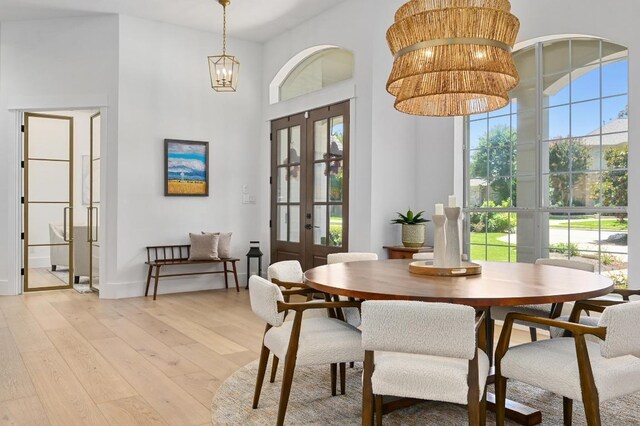 2314 Camino Del Verdes Pl, Round Rock, TX 78681 - dining area featuring french doors, light wood-style flooring, healthy amount of natural light, and a towering ceiling