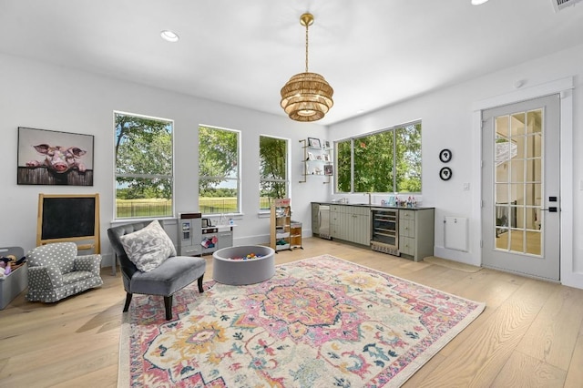 2314 Camino Del Verdes Pl, Round Rock, TX 78681 - living room with wine cooler, light wood finished floors, recessed lighting, and a chandelier