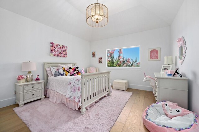 2314 Camino Del Verdes Pl, Round Rock, TX 78681 - bedroom featuring light wood-type flooring and a chandelier