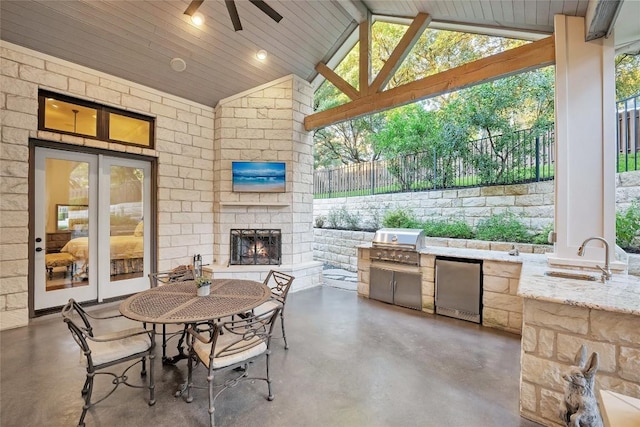 604 Flamingo Cv, Lakeway, TX 78734 - view of patio with an outdoor stone fireplace, area for grilling, and a ceiling fan