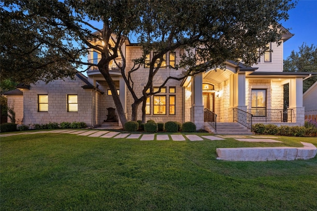 604 Flamingo Cv, Lakeway, TX 78734 - view of front facade with a front yard, stone siding, and covered porch