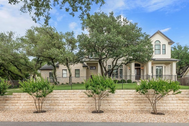 604 Flamingo Cv, Lakeway, TX 78734 - obstructed view of property featuring a fenced front yard and stone siding