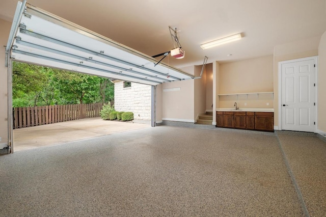 604 Flamingo Cv, Lakeway, TX 78734 - garage featuring a garage door opener and a sink