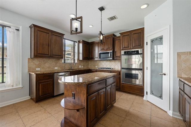 3443 Cortes Pl, Round Rock, TX 78665 - kitchen featuring stainless steel appliances, stone counters, tasteful backsplash, light tile patterned floors, and recessed lighting