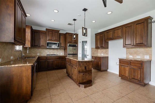 3443 Cortes Pl, Round Rock, TX 78665 - kitchen with stainless steel appliances, tasteful backsplash, light stone counters, and recessed lighting