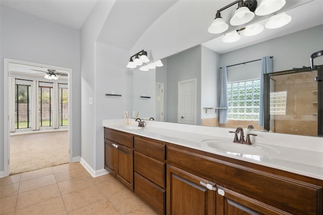 3443 Cortes Pl, Round Rock, TX 78665 - bathroom with double vanity, tile patterned floors, ceiling fan, and a shower with door