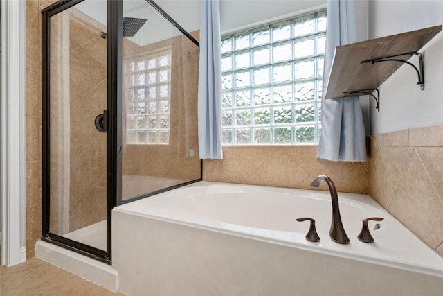 3443 Cortes Pl, Round Rock, TX 78665 - bathroom featuring a shower stall, a bath, and tile patterned floors