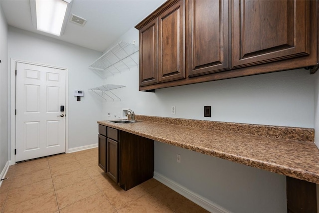 3443 Cortes Pl, Round Rock, TX 78665 - laundry area featuring washer hookup, light tile patterned floors, and cabinet space