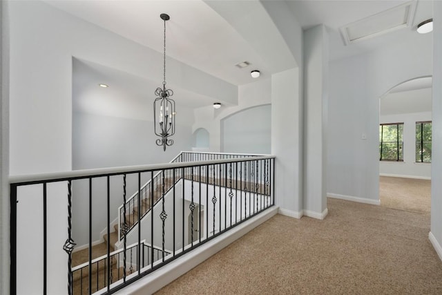 3443 Cortes Pl, Round Rock, TX 78665 - hallway with carpet flooring, a chandelier, and arched walkways