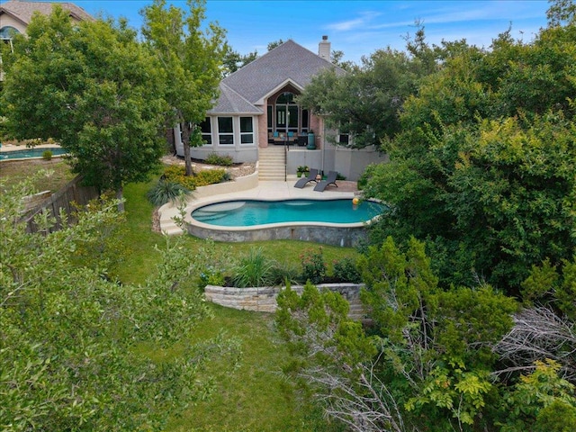 12464 Fairfax Ridge Pl, Austin, TX 78738 - rear view of house with an outdoor pool, a chimney, a patio area, and stairway