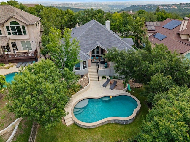 12464 Fairfax Ridge Pl, Austin, TX 78738 - back of property with stairway, a chimney, a wooden deck, and an outdoor pool