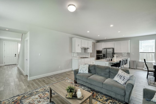 217 Stone Creek Dr, Georgetown, TX 78628 - living room featuring light wood finished floors and recessed lighting
