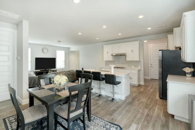 217 Stone Creek Dr, Georgetown, TX 78628 - dining space featuring light wood-style flooring and recessed lighting
