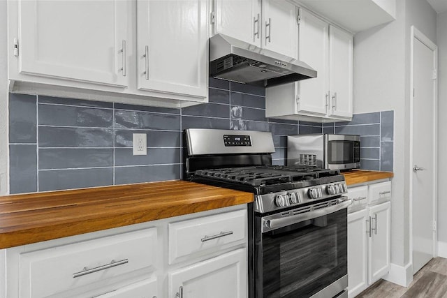 4904 Wing Rd, Austin, TX 78749 - kitchen featuring appliances with stainless steel finishes, under cabinet range hood, wooden counters, and white cabinets
