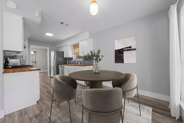 4904 Wing Rd, Austin, TX 78749 - dining area with baseboards and wood finished floors