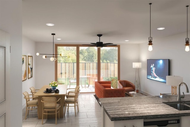 300-304 Tesla Cir, Austin, TX 78681 - kitchen featuring a ceiling fan, recessed lighting, hanging light fixtures, dark stone counters, and light wood-type flooring