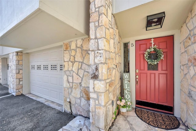 200 Free Rein Unit 5, Horseshoe Bay, TX 78657 - doorway to property featuring stone siding and a garage