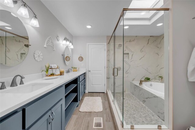 200 Free Rein Unit 5, Horseshoe Bay, TX 78657 - full bath featuring double vanity, a garden tub, a marble finish shower, recessed lighting, and wood finished floors
