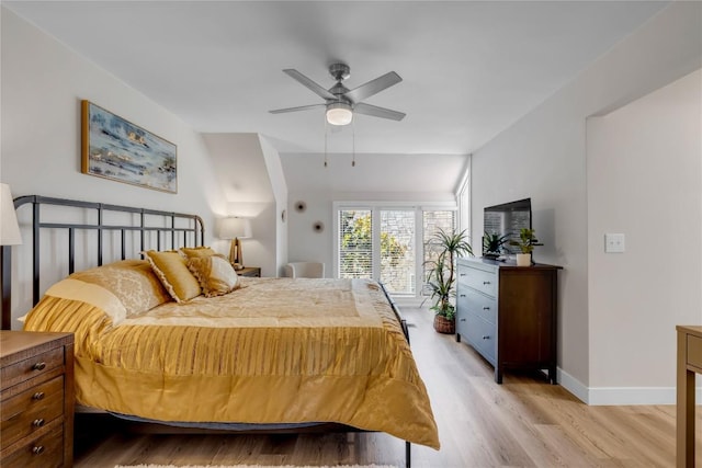 200 Free Rein Unit 5, Horseshoe Bay, TX 78657 - bedroom with light wood finished floors and a ceiling fan