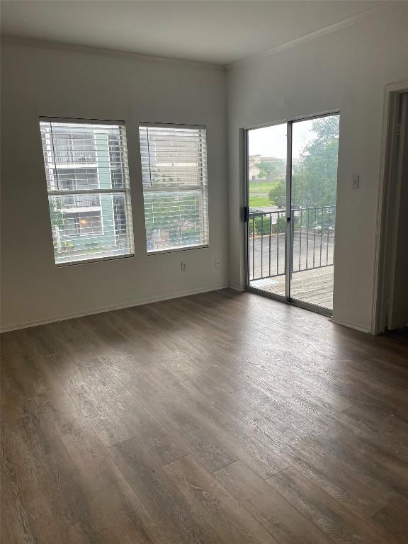 12166 Metric Blvd Unit 243, Austin, TX 78758 - empty room with wood finished floors and crown molding
