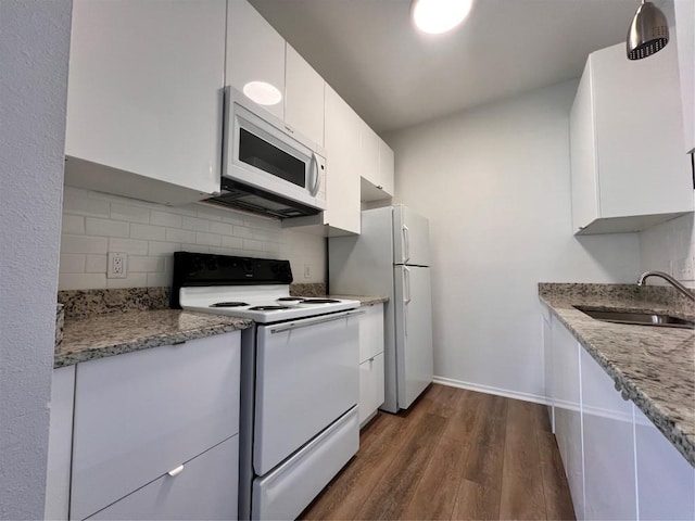 12166 Metric Blvd Unit 243, Austin, TX 78758 - kitchen featuring white appliances, dark wood-type flooring, white cabinets, backsplash, and light stone countertops