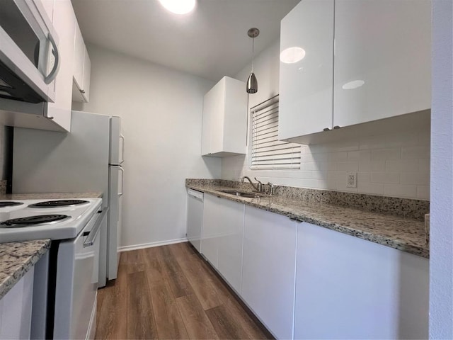 12166 Metric Blvd Unit 243, Austin, TX 78758 - kitchen with white appliances, white cabinetry, dark wood-style flooring, and light stone counters