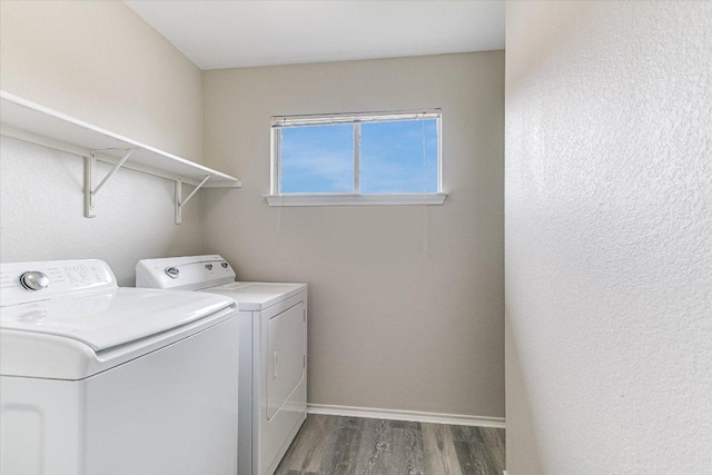 1000 Warbler Cv, Hutto, TX 78634 - laundry area featuring washer and clothes dryer and wood finished floors