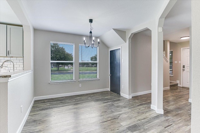1000 Warbler Cv, Hutto, TX 78634 - unfurnished dining area with a chandelier and light wood-type flooring