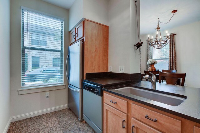 1201 Grove Blvd Unit 1404, Austin, TX 78741 - kitchen featuring dishwashing machine, a chandelier, freestanding refrigerator, and plenty of natural light