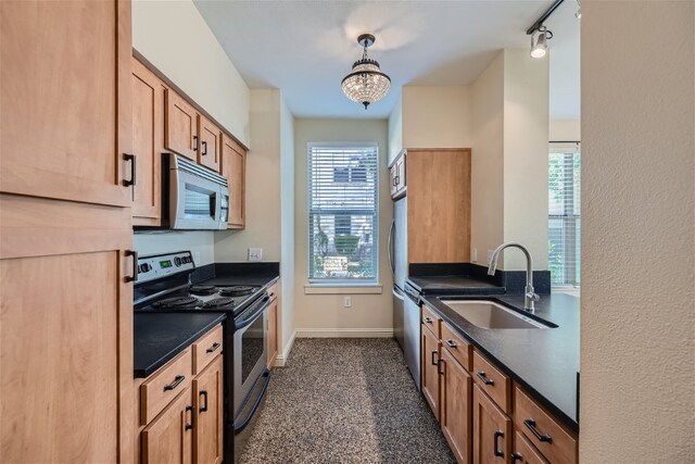 1201 Grove Blvd Unit 1404, Austin, TX 78741 - kitchen featuring stainless steel appliances, dark countertops, and decorative light fixtures