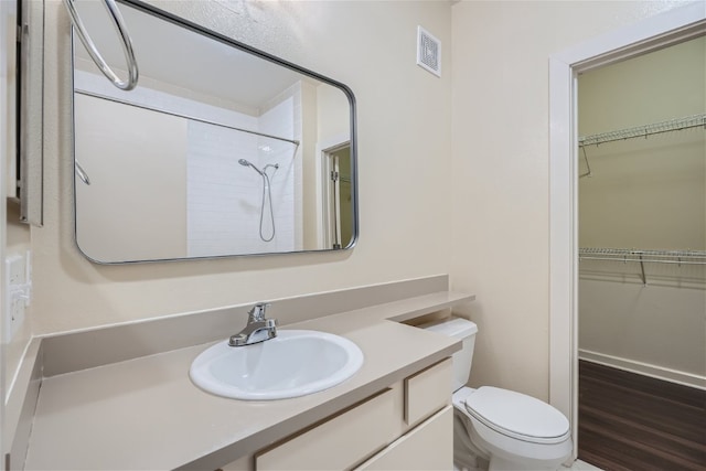 1201 Grove Blvd Unit 1404, Austin, TX 78741 - full bathroom featuring vanity, a shower, and a walk in closet
