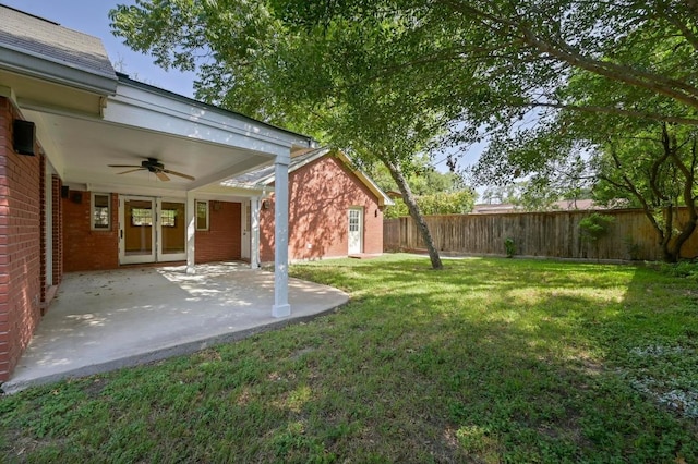 2710 Greenlawn Pkwy, Austin, TX 78757 - fenced backyard with a ceiling fan and a patio