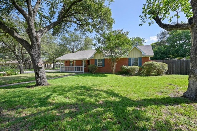 2710 Greenlawn Pkwy, Austin, TX 78757 - ranch-style house with a porch and brick siding