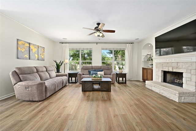 1903 Chula Vista Dr, Cedar Park, TX 78613 - living room featuring a ceiling fan, light wood-style floors, crown molding, and a fireplace