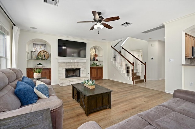 1903 Chula Vista Dr, Cedar Park, TX 78613 - living area featuring a ceiling fan, light wood-type flooring, stairway, and a fireplace