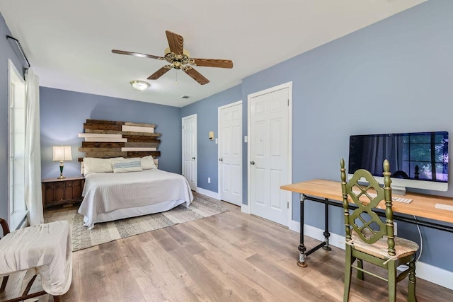 13223 Broadmeade Ave, Austin, TX 78729 - bedroom featuring wood finished floors, a ceiling fan, and multiple closets