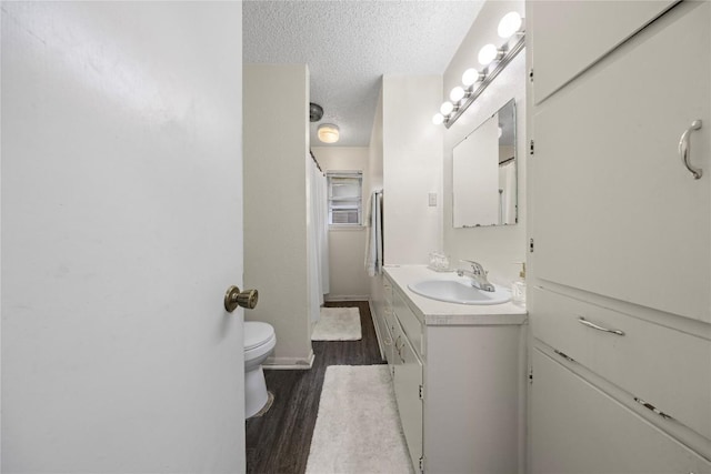 2016 Wanda St, Copperas Cove, TX 76522 - full bathroom featuring a textured ceiling, vanity, and wood finished floors