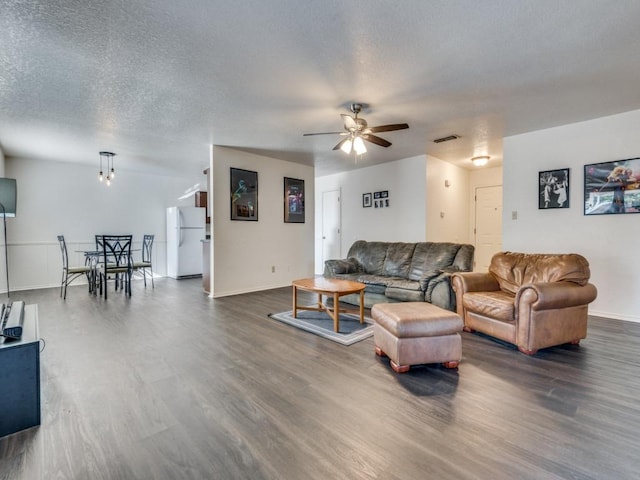 4503 Lori Dr, Killeen, TX 76549 - living area featuring a ceiling fan, dark wood-style flooring, and a textured ceiling
