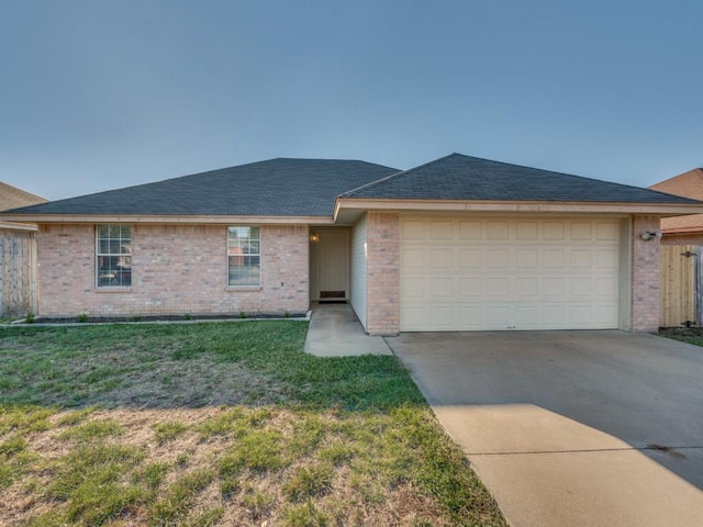 4503 Lori Dr, Killeen, TX 76549 - ranch-style home featuring brick siding, concrete driveway, a garage, a front lawn, and a shingled roof
