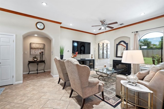 700 Canyon Bend Rd, Pflugerville, TX 78660 - living room featuring recessed lighting, a ceiling fan, ornamental molding, arched walkways, and a glass covered fireplace
