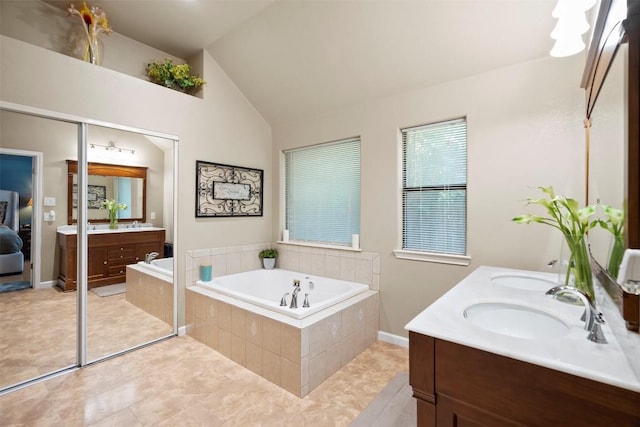 700 Canyon Bend Rd, Pflugerville, TX 78660 - bathroom featuring double vanity, a bath, vaulted ceiling, and tile patterned flooring