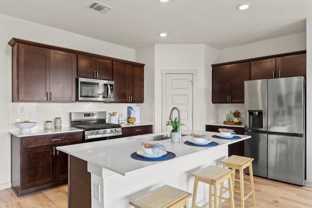 10708 Defender Trl, Austin, TX 78754 - kitchen with stainless steel appliances, light wood-style floors, light countertops, tasteful backsplash, and recessed lighting