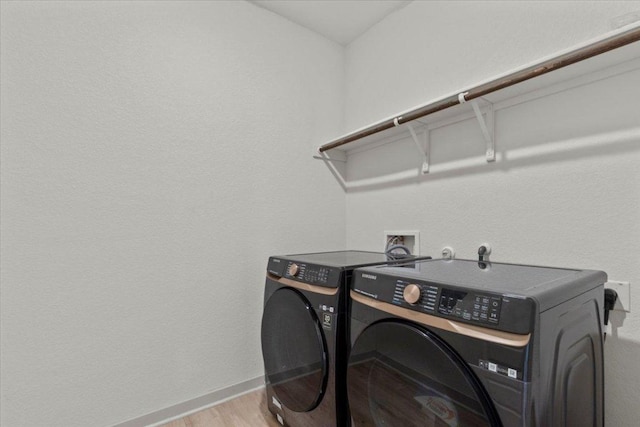 10708 Defender Trl, Austin, TX 78754 - washroom with washer and clothes dryer and light wood-type flooring