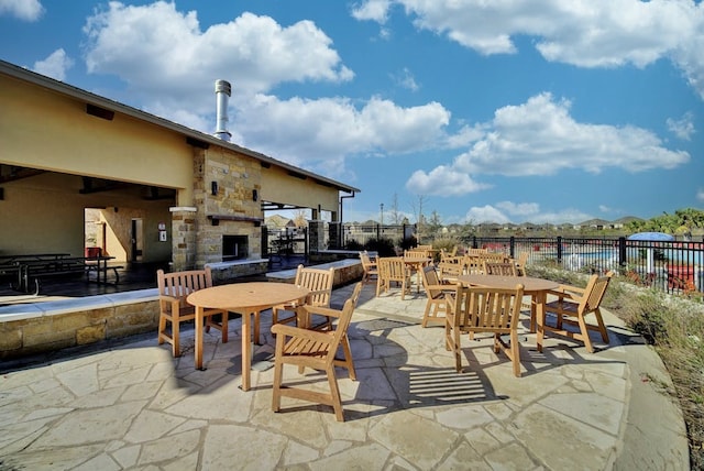 12908 Thomas Jefferson St, Manor, TX 78653 - view of patio featuring an outdoor stone fireplace and outdoor dining area