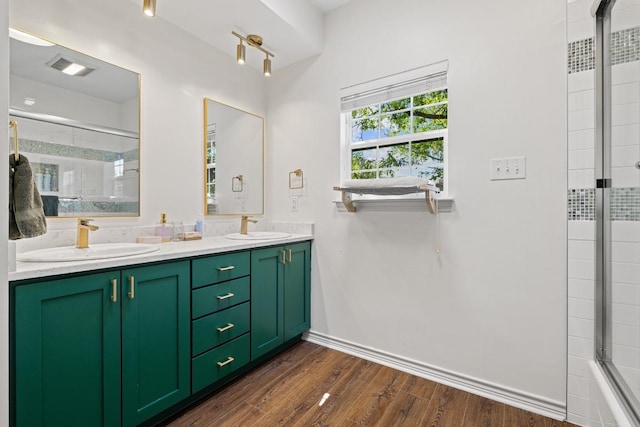3702 Terrina St Unit 12, Austin, TX 78759 - bathroom featuring tiled shower, double vanity, and wood finished floors