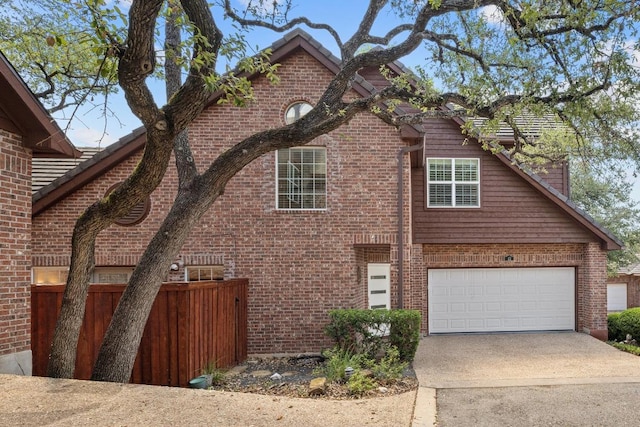 3702 Terrina St Unit 12, Austin, TX 78759 - view of front of house featuring concrete driveway, brick siding, and an attached garage