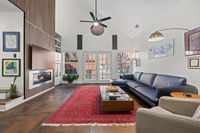 3702 Terrina St Unit 12, Austin, TX 78759 - living area with high vaulted ceiling, a ceiling fan, a glass covered fireplace, and french doors