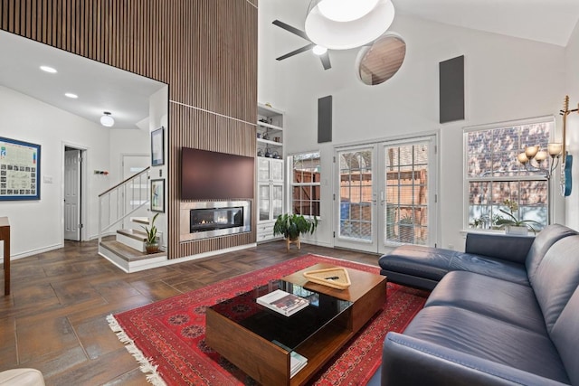 3702 Terrina St Unit 12, Austin, TX 78759 - living area featuring a high ceiling, stairs, a ceiling fan, a glass covered fireplace, and french doors