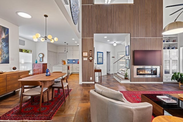 3702 Terrina St Unit 12, Austin, TX 78759 - living area with stairway, a glass covered fireplace, a chandelier, recessed lighting, and a high ceiling