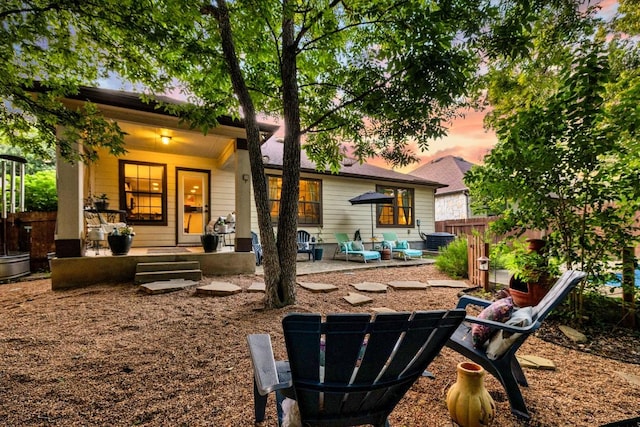 1149 Hyde Park Dr, Round Rock, TX 78665 - back of house at dusk with a porch